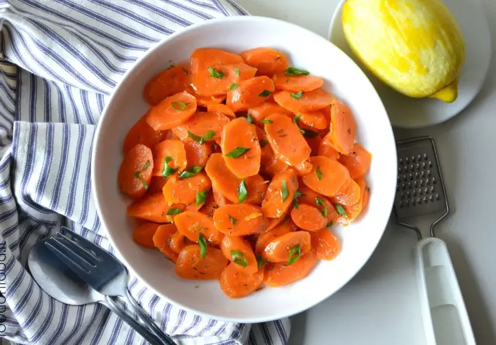Carote al limone, fresche e profumate, guarnite con erbe aromatiche. Un contorno semplice e gustoso.