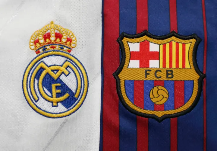 Emblematy Realu Madryt i FC Barcelony obok siebie. Kto jest lepszy, Real czy Barca? Odwieczna rywalizacja na koszulkach.
