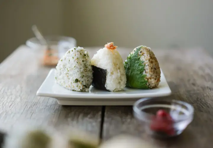 Three delicious rice balls with seaweed, seasoned and ready to eat.