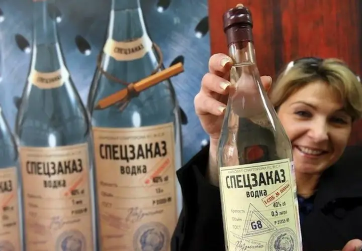 Kobieta trzyma butelkę wódki "Speczakaz", która opowiada historię, skąd pochodzi wódka.