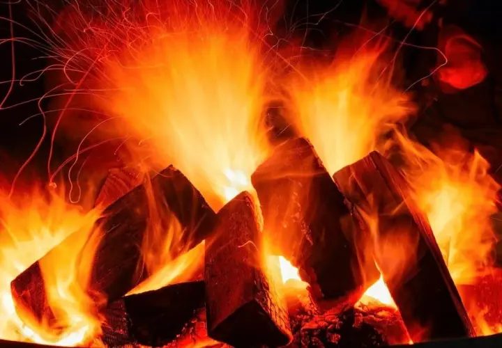 Flammen tanzen um Holzscheite, die zu einem knisternden Feuer werden. Ob buche hart oder weichholz, die Glut verspricht Wärme.