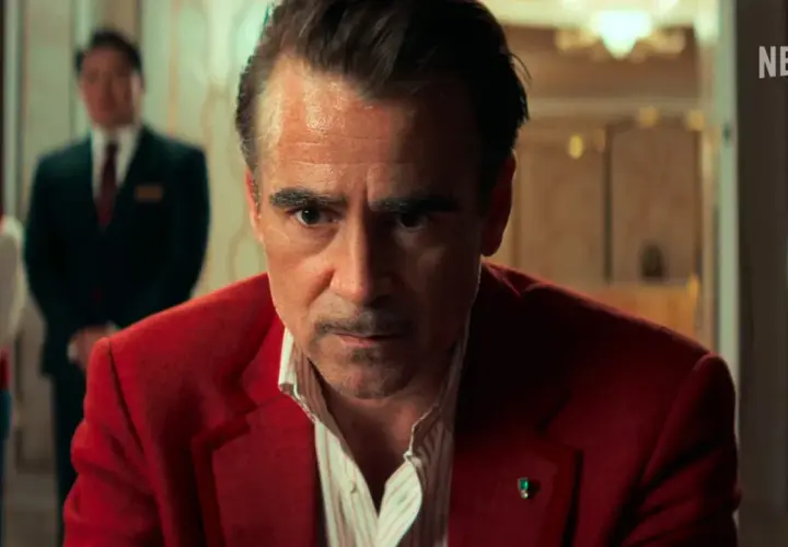Colin Farrell in un film Netflix, con un'espressione intensa, indossa una giacca rossa.