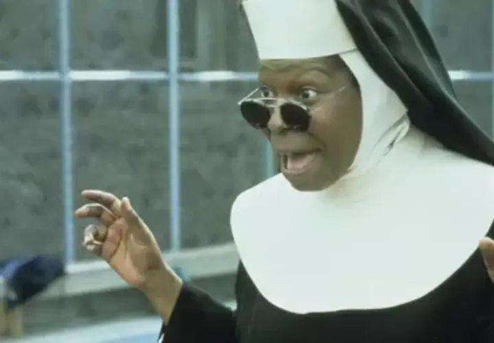 Whoopi Goldberg w roli siostry w filmie "Zakonnica w przebraniu 2: Powrót do habitu" z okularami i w rozbawionej pozie.