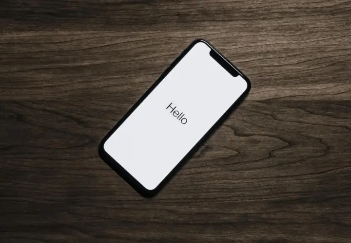 Telefon z napisem "Hello" na białym ekranie. Idealny moment, by pomyśleć, jak zaprosić dziewczynę na randkę.