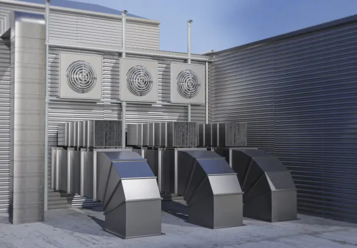 Unidades exteriores de un sistema VRV, con conductos metálicos y ventiladores en una pared acanalada.