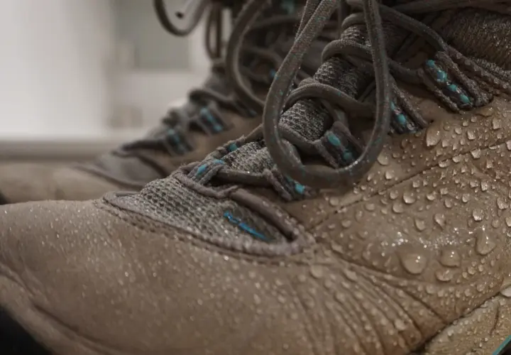 Water droplets on hiking boots. Learn how to clean inside of boots after a muddy adventure.