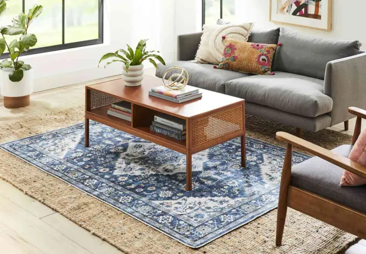 Layering a patterned blue rug over a jute rug creates depth. A 5x8 or 6x9 rug would work well to layer over an 8x10.