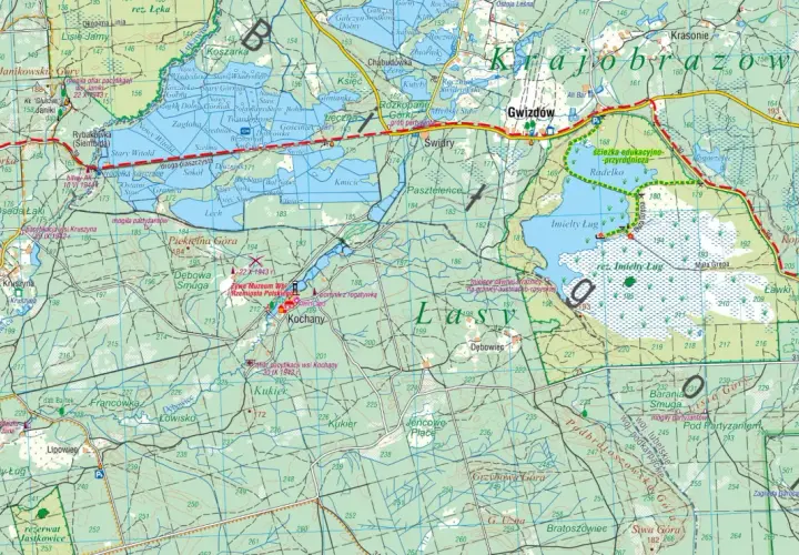 Mapa turystyczna przedstawiająca **lasy janowskie** z zaznaczonymi szlakami, rezerwatami i miejscami pamięci.