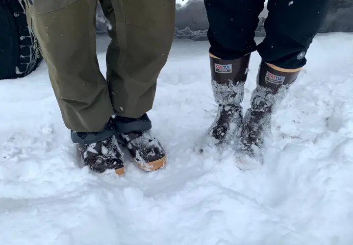 Two pairs of winter boots in snow. The Xtratuf boots fit snugly, allowing for thick socks.