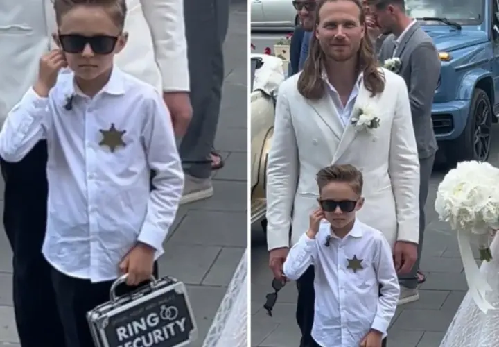 Chłopiec w okularach przeciwsłonecznych, z odznaką i walizeczką "Ring Security", towarzyszy parze młodej.