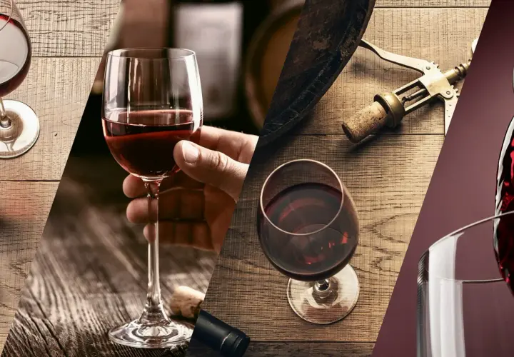 Calici di vino rosso, tappi di sughero e cavatappi su tavoli di legno. Un'ode a i vini più pregiati d'Italia.