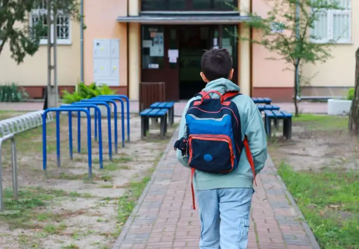 Chłopiec z plecakiem idzie do szkoły. Czy religia wlicza się do czerwonego paska?