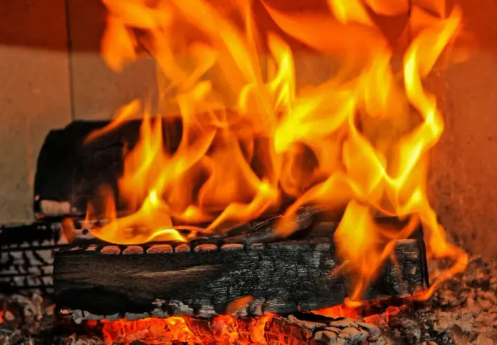 Glühende Kohlen und Flammen zeigen den hohen **erle brennwert** eines Kaminfeuers.