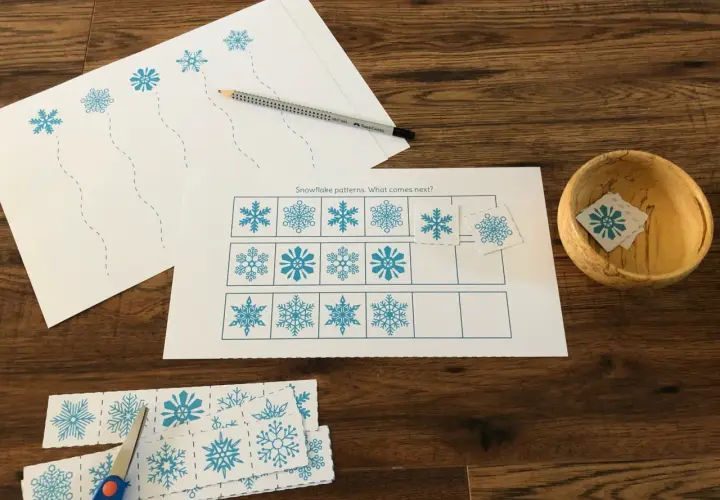 Actividades invierno Montessori: hojas con copos de nieve para recortar y completar patrones. Tijeras y lápiz listos.