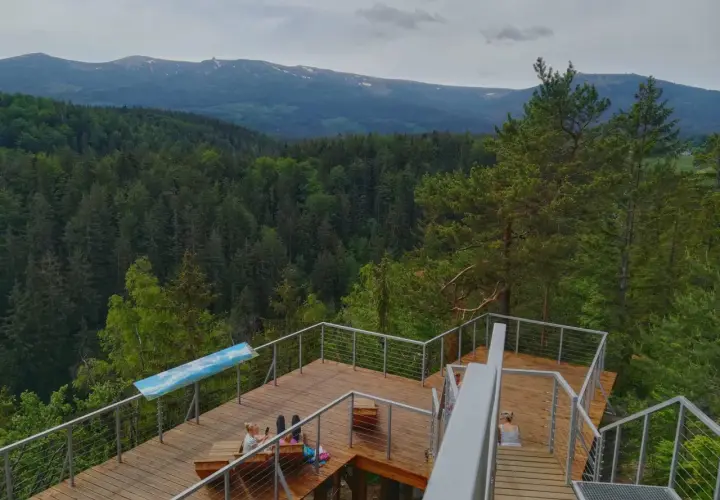 Drewniany taras z widokiem na góry i las. Idealne miejsce na relaks w Karpaczu, restauracja z widokiem zachwyca.
