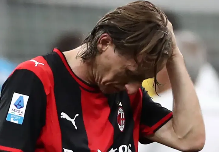 Piłkarz Milanu z opuszczoną głową, zmartwiony po przegranym meczu w Serie A. Tabela liga włoska nie wygląda dziś dla niego dobrze.
