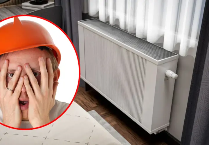 Zmartwiony mężczyzna w kasku przy grzejniku. Czyżby czekało go przelewanie wody w grzejniku?