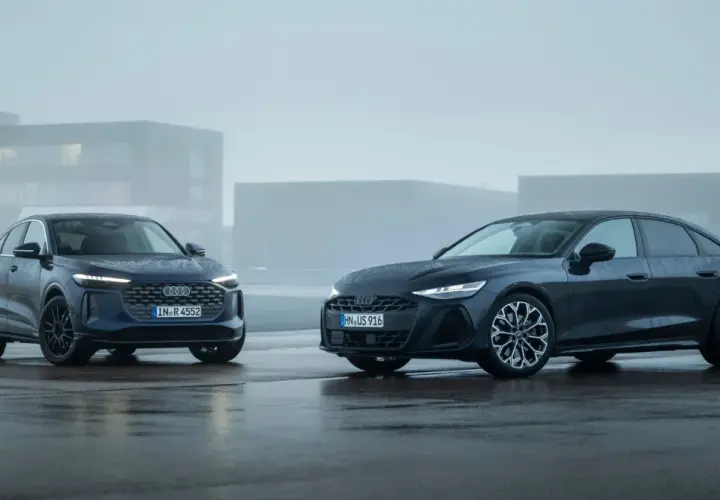 Dwa Audi, SUV i sedan, błyszczą na mokrym asfalcie. Jeden z nich to potężne 3.0 TDI, gotowe na każdą drogę.