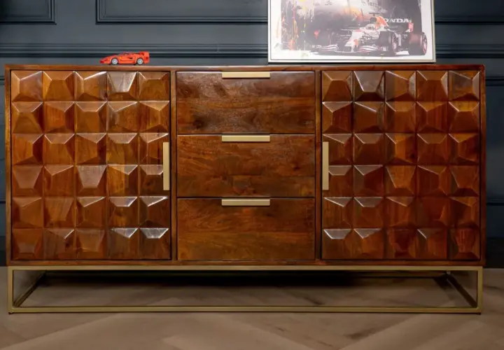 A geometric carved mango wood finish sideboard with brass handles and a gold metal base.