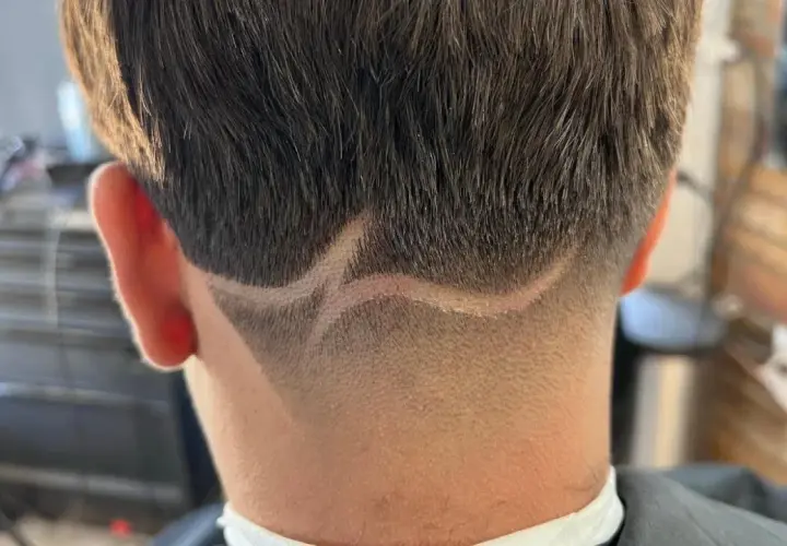 Corte de pelo con diseño en zig-zag y un taper fade impecable en la nuca.
