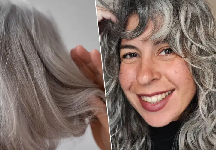 Una mujer sonríe mostrando su cabello con canas, que luce rizado y con mechones plateados.