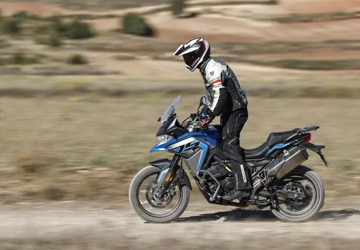 Motociclista en una Voge 650 DSX azul, probando sus capacidades off-road. Las voge 650 dsx opiniones son positivas.