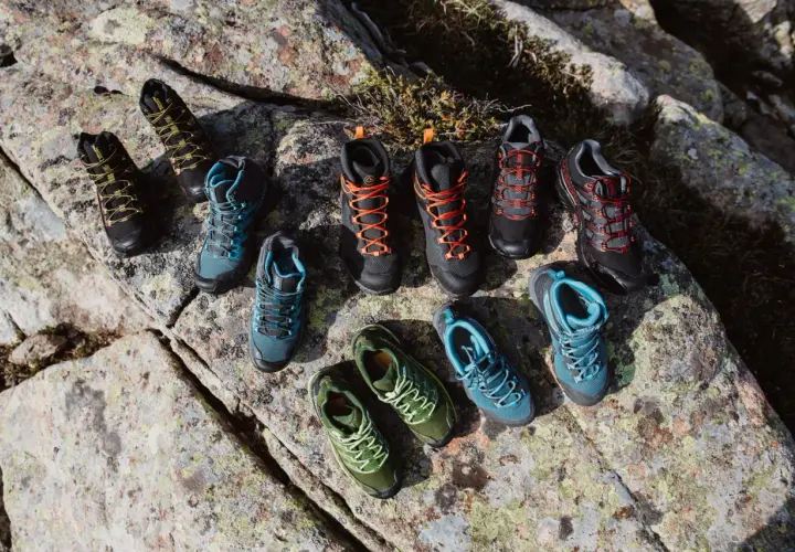 A collection of hiking boots and shoes in various colors, arranged on rocks. Even well-made shoes can degrade over time if not worn, a process that can seem mysterious.