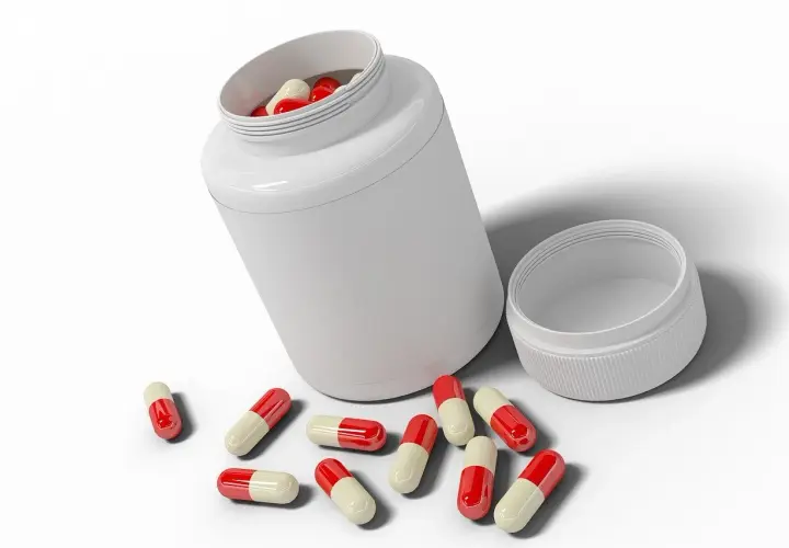 Flacone bianco con capsule rosse e bianche sparse. Informazioni su quercetina controindicazioni.