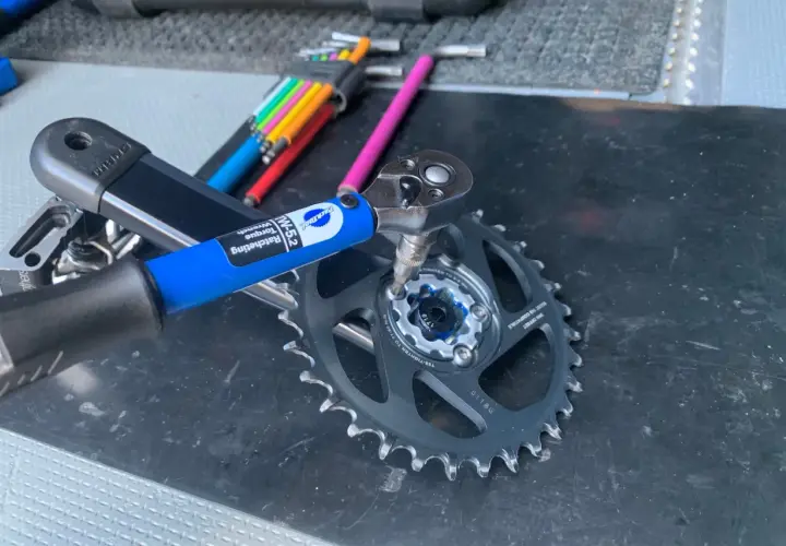 Using a Park Tool torque wrench to ensure proper SRAM chainring bolt torque for a bike repair.