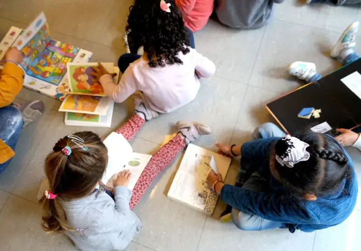 Niños aprendiendo a leer, quizás con ayuda del bono infantil Comunidad Valenciana.