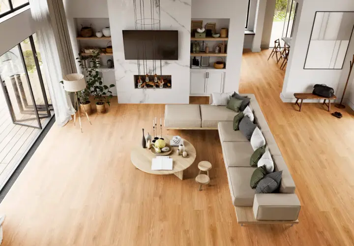 Soggiorno moderno con divano angolare, tavolino rotondo e camino. Il calore del legno dei pavimenti LVT crea un'atmosfera accogliente.