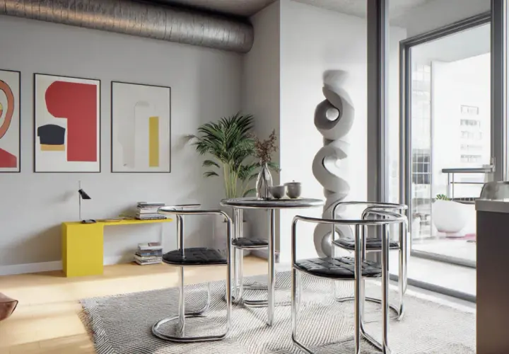 Nowoczesne wnętrze w stylu bauhaus: okrągły stolik z krzesłami, abstrakcyjne obrazy, żółta konsola i rzeźba.