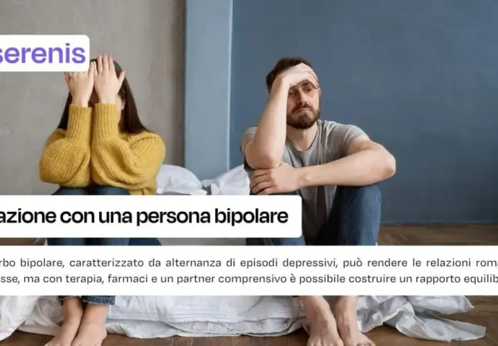 A couple sits apart on a bed, one covering their face, the other holding their head.