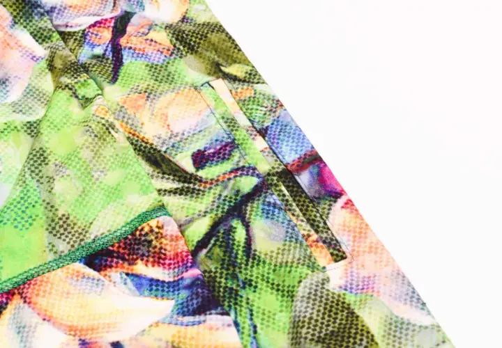 Close-up of a pocket on colorful floral leggings, showing how to add pockets to leggings with neat stitching.