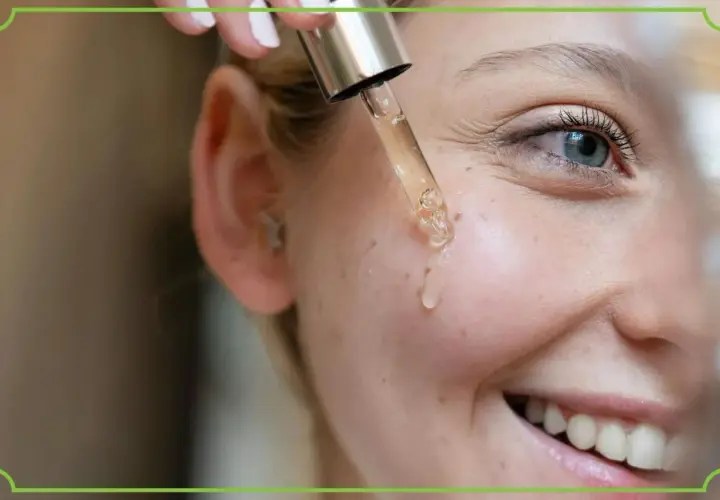 Kropla serum z pipety ląduje na policzku. Czy retinol to witamina A? Tak, to pochodna witaminy A, kluczowa dla zdrowej skóry.