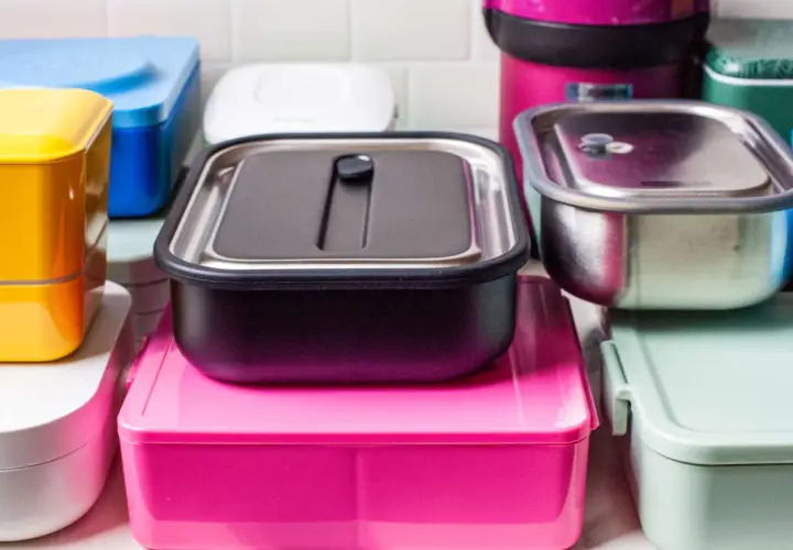 A colorful assortment of various types of bento boxes, including stainless steel, plastic, and stacked designs, ready for a delicious meal.