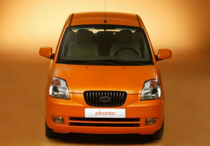 Vista frontale di una Kia Picanto arancione. Nonostante il suo aspetto allegro, alcuni proprietari segnalano **kia picanto difetti** comuni.
