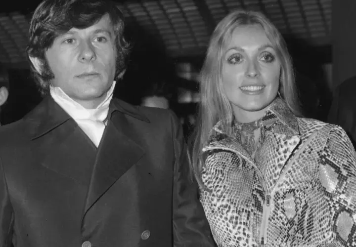Roman Polański i jego żona Sharon Tate, uśmiechnięci, pozują do zdjęcia.