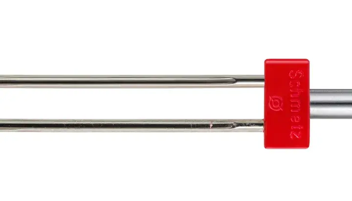 A twin sewing machine needle with a red Schmetz shank. This helps you decide what sewing machine needle to use for decorative stitches.