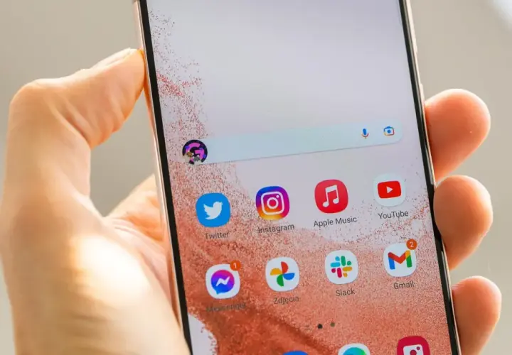 Jak ustawić aparat w Samsung S22? Na ekranie telefonu widać ikony aplikacji: Twitter, Instagram, Apple Music, YouTube, Messenger, Zdjęcia, Slack, Gmail.