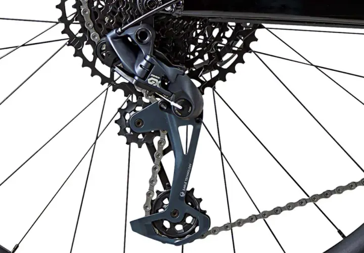 Close-up of a bicycle's rear derailleur with a bent derailleur hanger, showing the cassette and chain.