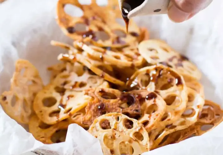 Crispy lotus root chips drizzled with a dark sauce, a simple and delicious addition to your easy Japanese recipes.