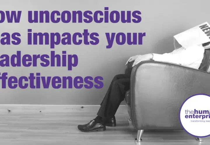 A man sits with a newspaper over his head, symbolizing how unconscious bias coaching can improve leadership effectiveness.