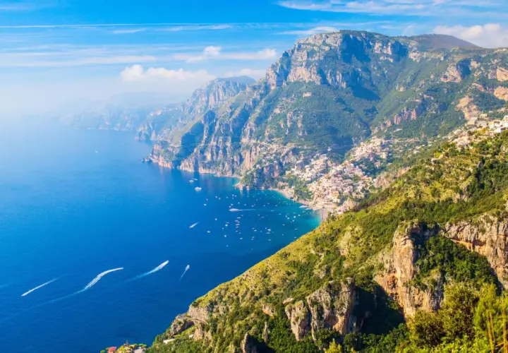 A stunning view of the Amalfi Coast, where the Path of the Gods winds through dramatic cliffs overlooking the azure sea.