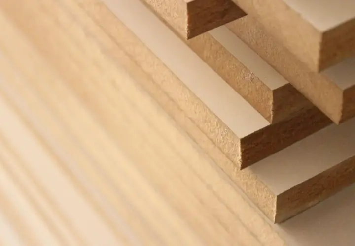 Stack of solid mdf boards, showing their layered construction and fine texture.