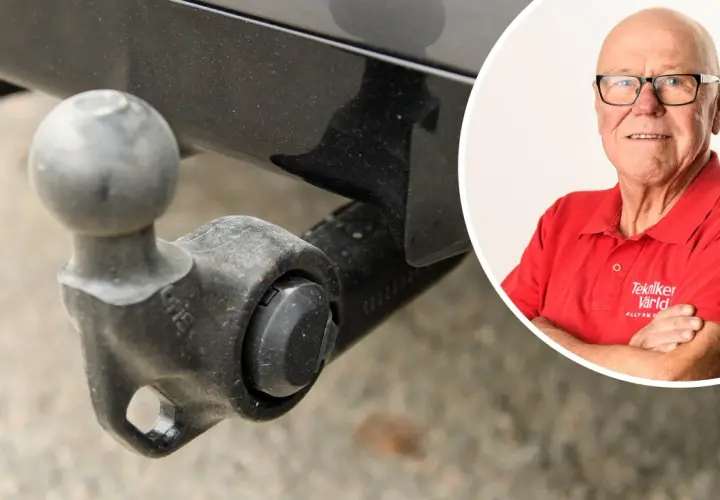 En man i röd tröja med texten "Tekniker Värld" ler. Bredvid syns en dragkrok, kanske för en besiktning.