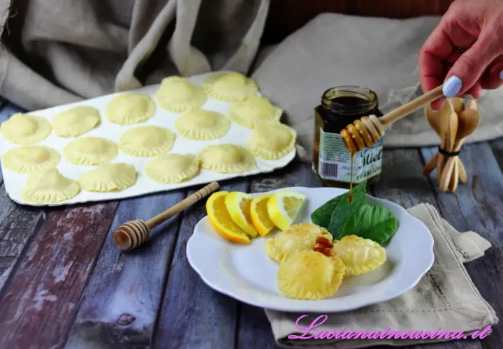 Seadas pronte per essere fritte, con miele, limone e arancia come ingredienti.