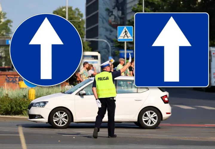 Policjant kieruje ruchem przy znakach "droga jednokierunkowa". Biała strzałka na niebieskim tle informuje o kierunku jazdy.