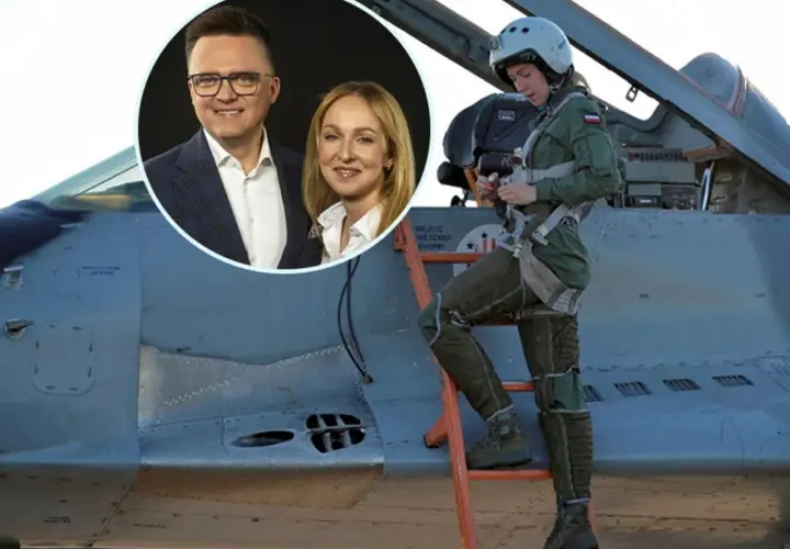 Urszula Brzezińska Hołownia w kombinezonie pilota obok myśliwca. W tle uśmiechnięci Szymon Hołownia i jego żona.