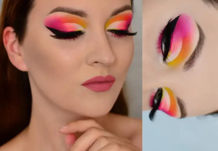 Wyrazisty makijaż oczu w stylu cut crease z neonowym gradientem od żółci, przez róż, po fiolet. Czarne kreski i długie rzęsy podkreślają spojrzenie.